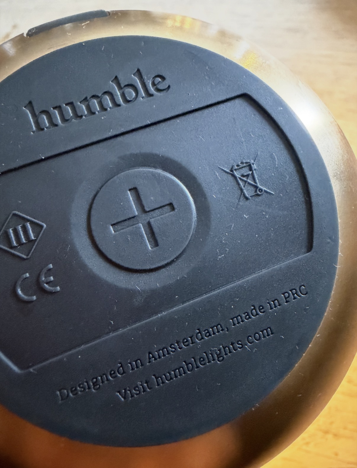 Underside of a restaurant table light marked Designed in Amsterdam, made in PRC