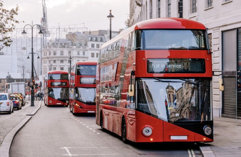 Red London buses on a busy central London street
