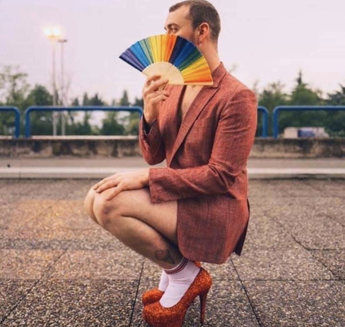 Sam Smith performing with a rainbow fan