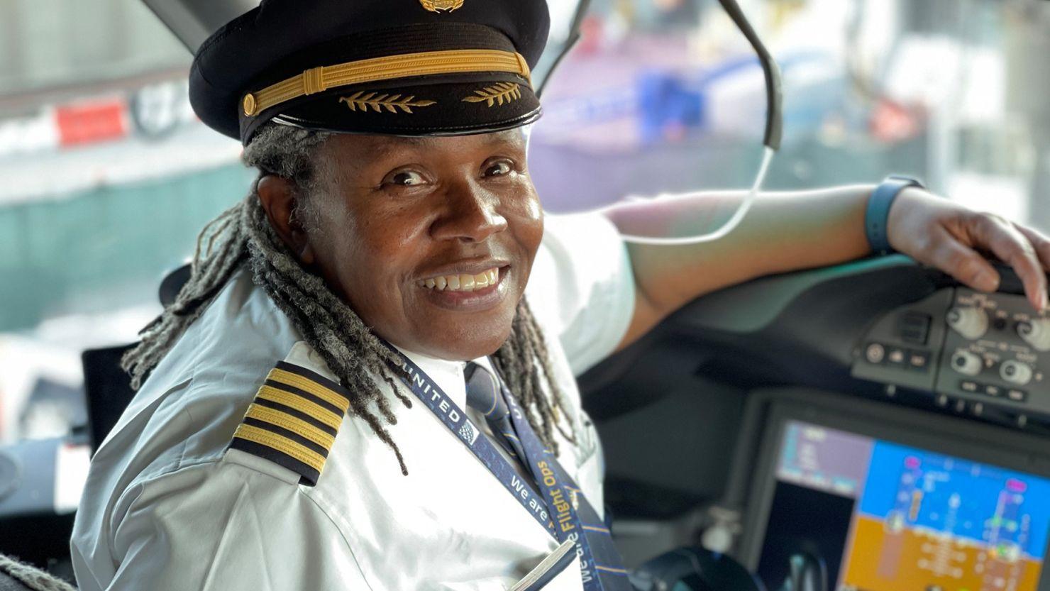 Captain Theresa Claiborne seated in an aircraft cockpit