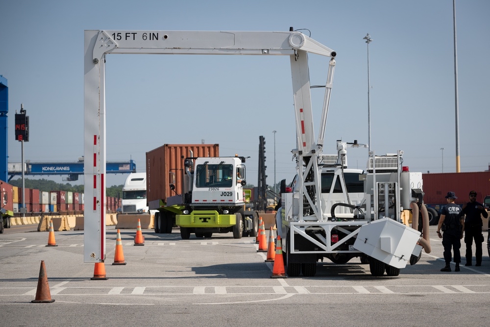 Freight containers passing through a modern customs inspection and scanning facility