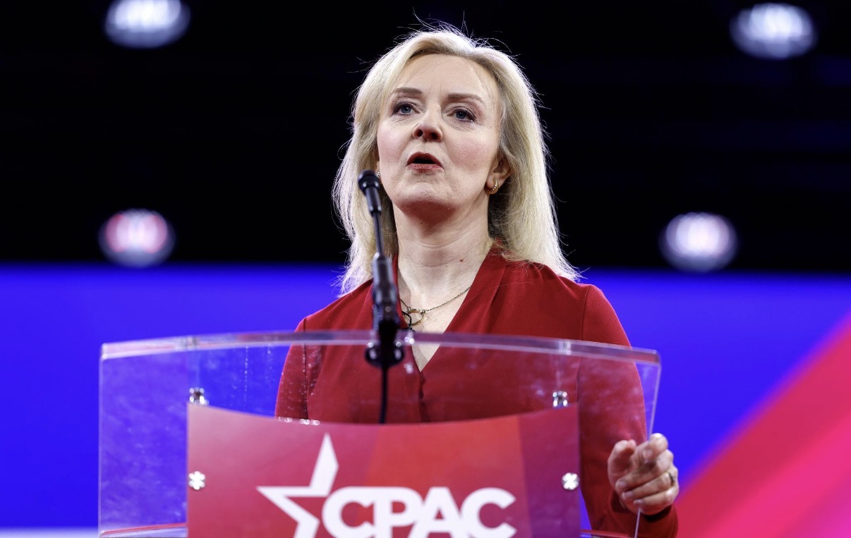 Liz Truss speaking from a lectern at CPAC.