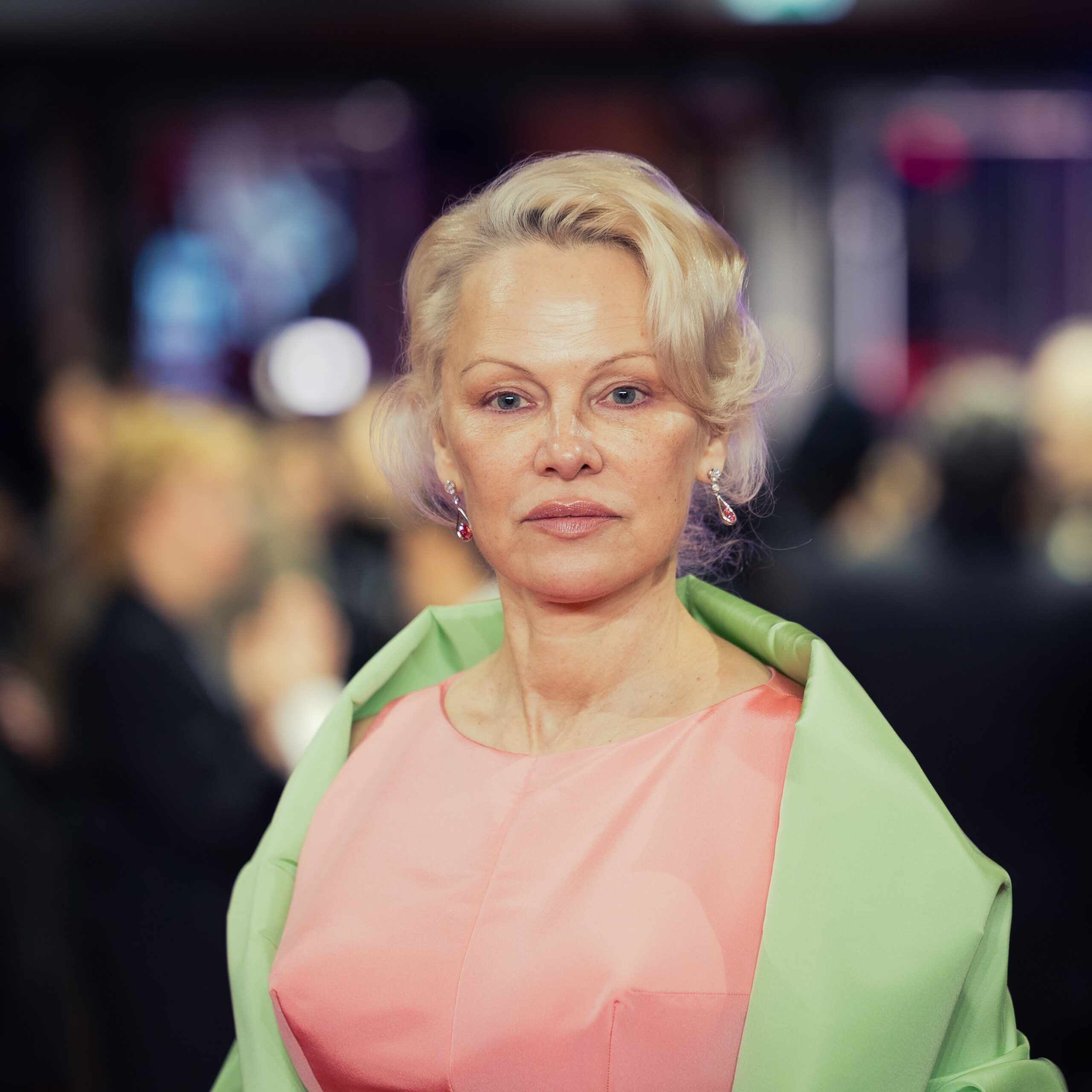 Pamela Anderson looking directly into the camera at the 2026 Berlin International Film Festival.