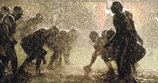 Miami Sharks players competing during a rain-soaked American football match