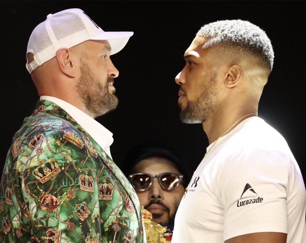 Tyson Fury and Anthony Joshua facing each other at the London press conference for their 2026 fight