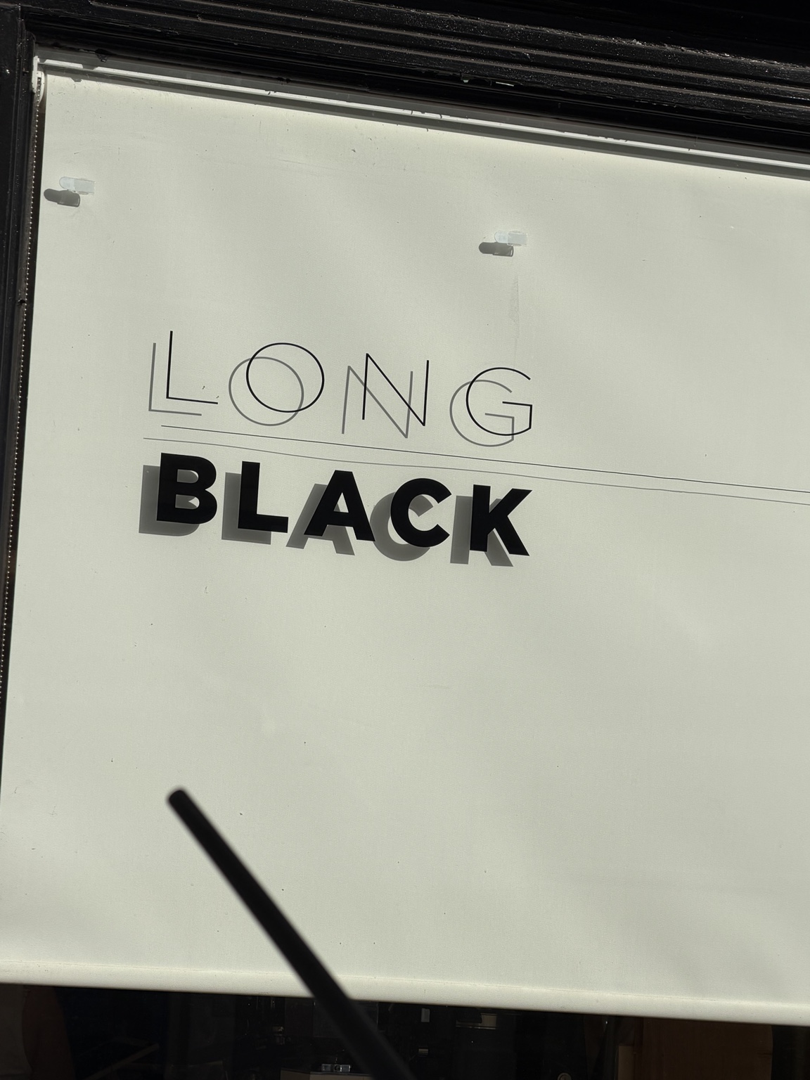 Close-up of the Long Black sign: LONG in fine lettering and BLACK beneath it in bold.