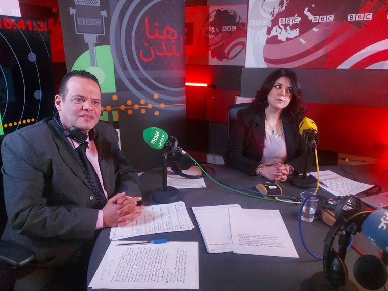 A male and female broadcaster working inside a BBC World Service radio studio